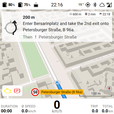 Map view in day mode with a turn-by-turn instruction, street name plate, and speed-limit sign